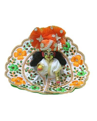 Laddu Gopal Dressed In White Floral Poshak With Vibrant Orange Pagdi For Festive Occasions