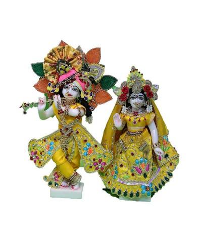 Vibrant Radha Krishna Idol Pair In Bright Yellow Traditional Dress With Multicolor Embellishments And Designer Crowns For Janmashtami And Special Occasions