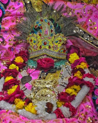Radhaballav Ji Poshak Featuring a Gemstone Crown and Vibrant Flower Garlands