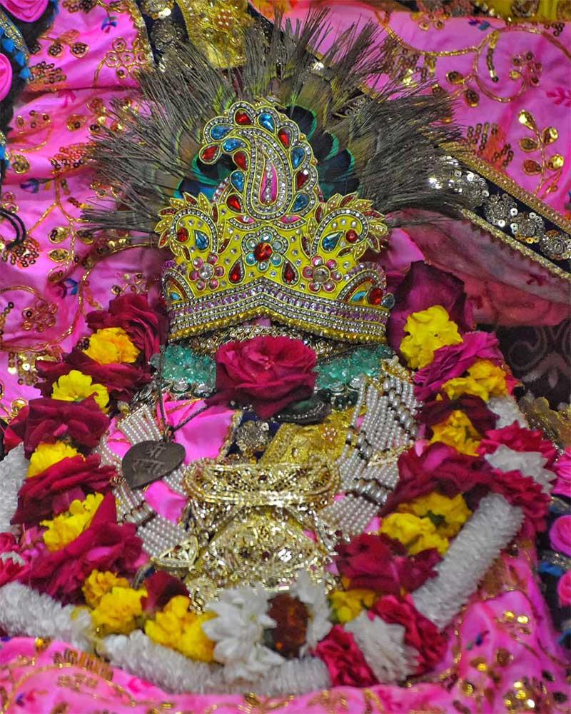Radhaballav Ji Poshak Featuring a Gemstone Crown and Vibrant Flower Garlands Radhaballav Ji Poshak Featuring a Gemstone Crown and Vibrant Flower Garlands